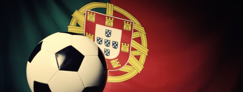 Flag of Portugal with football on wooden boards as the background. Vintage Style.
