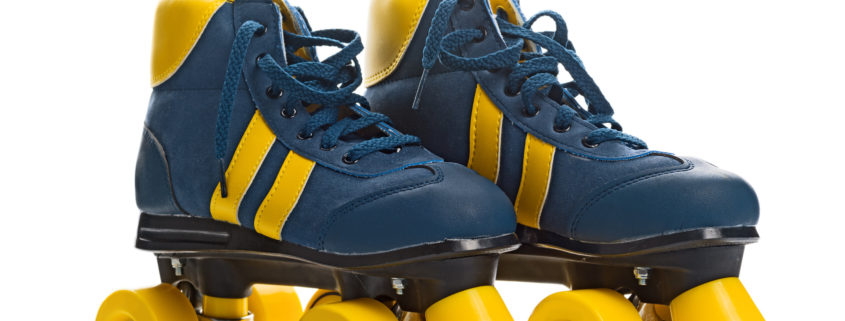 Vintage Retro Blue and Yellow Quad Roller Skates on White Background with Reflection.