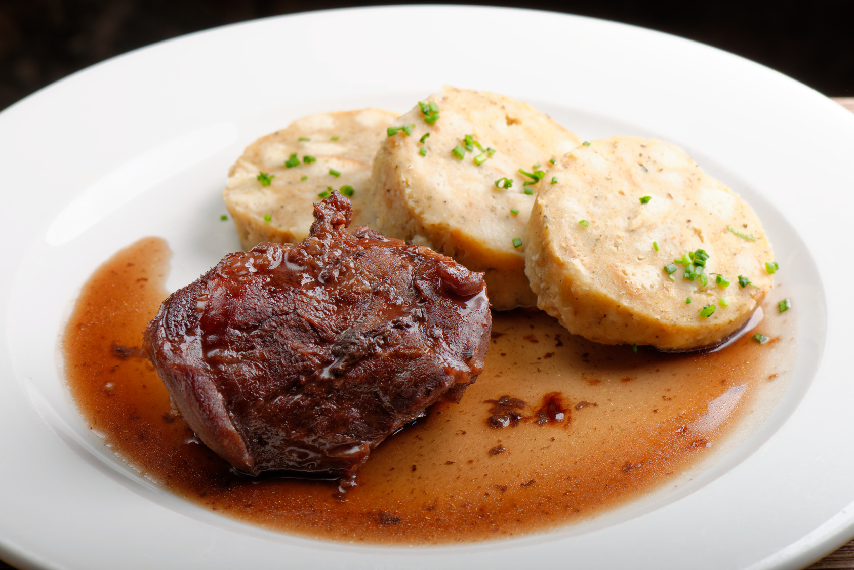Veal fillet with rich sauce and dumplings - traditional Czech dish