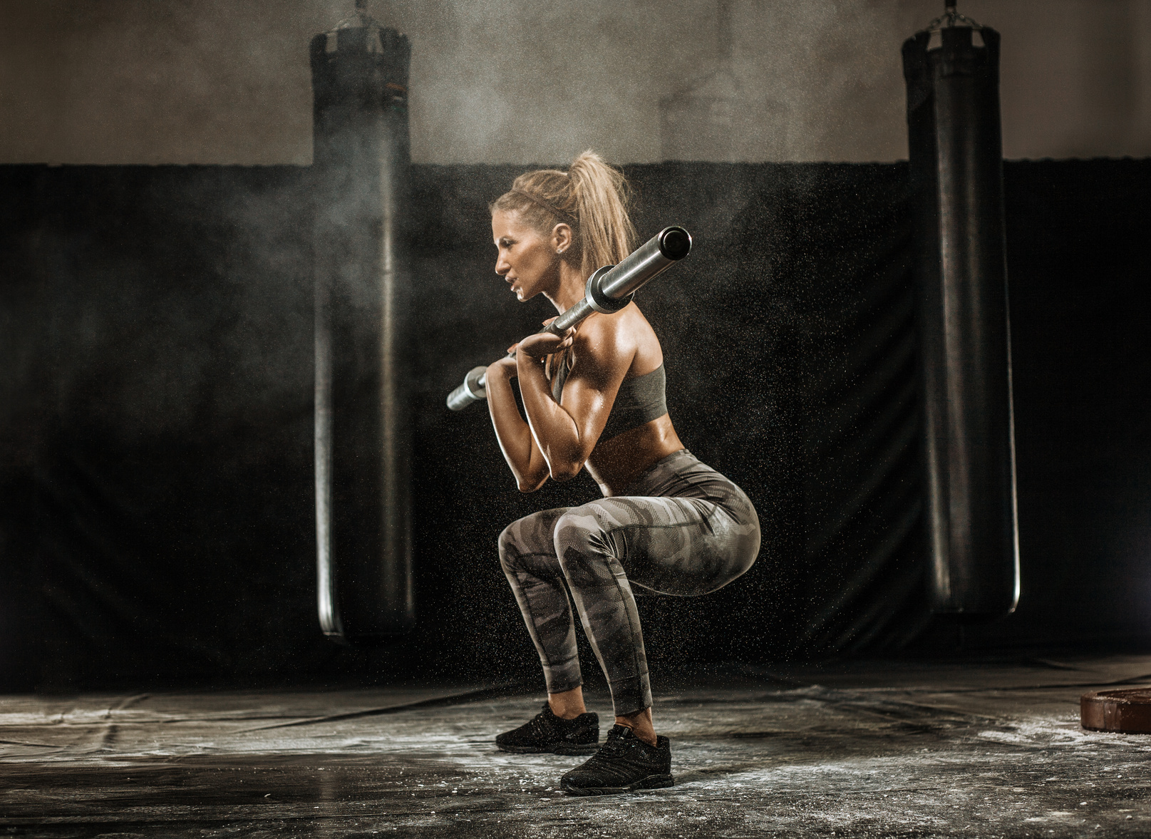 sporty girl squats with barbell training