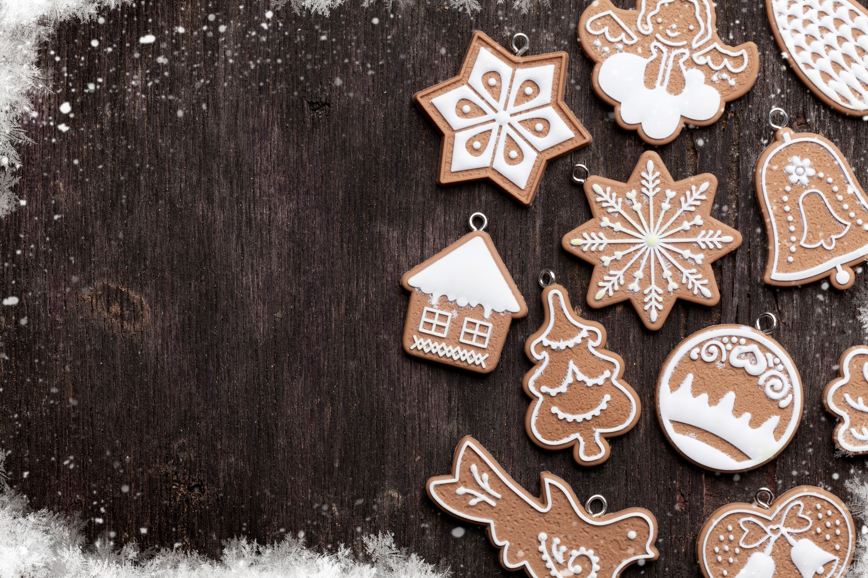 Christmas wooden background with gingerbread cookies. Top view with copy space for your greetings