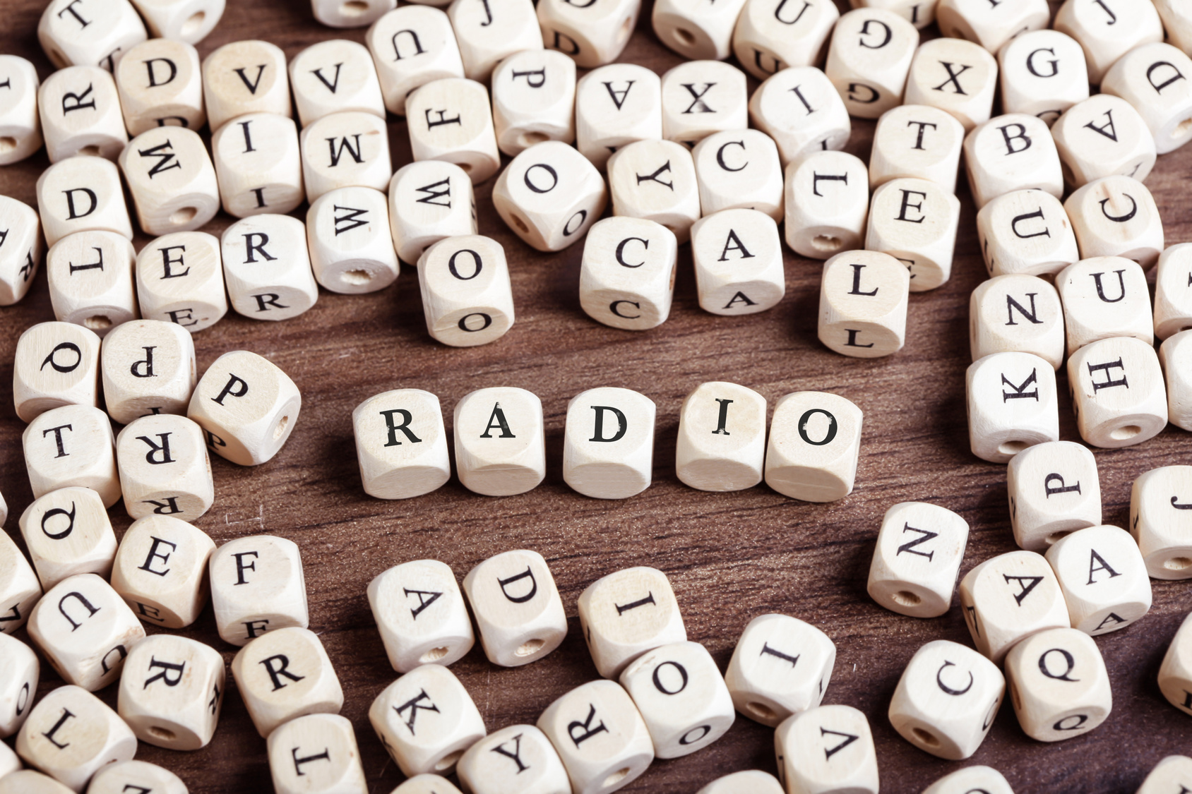 Word radio in letters on cube dices on table.